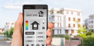 Smartphone with remote smart home control system - futuristic smart home concept