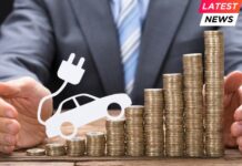Businessman Protecting Coins With Electric Car At Table