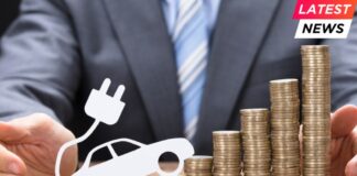 Businessman Protecting Coins With Electric Car At Table