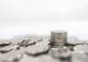 Business, Money, Finance, Security and Saving Concept. Close up of pile and stack of silver coins on white background and copy space.
