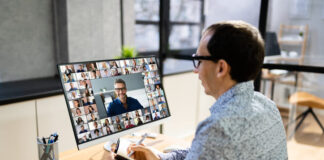 Manager monitoring his colleagues through video call