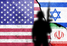 Flags of United States of America, Israel and Iran painted on the concrete wall with soldier shadow.