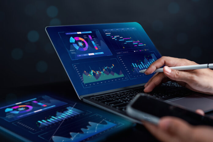 Analyst working with computer in Business Analytics and Data Management System