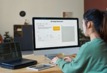 Young female designer sitting in front of desktop computer with AI image generator on screen and typing on keypad