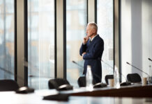 CEO thinking while standing by the window in the office