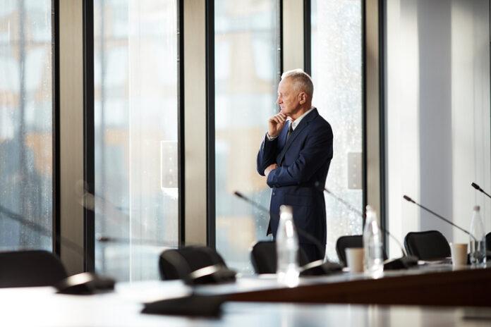 CEO thinking while standing by the window in the office
