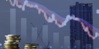 Coins stack and stock market investment graph,concept of business investment, stock future trading , clash and bear market with real estate background.