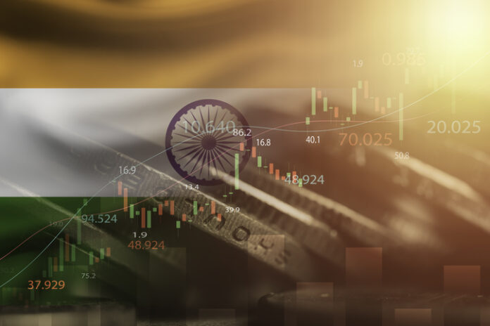 Double exposure among of coins stacking , stock market graph chat and India flag for India country is big economy and high business development growth from many investment
