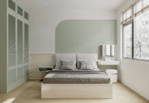 The interior of a bright bedroom features white and green paint on the wall, and green cabinet