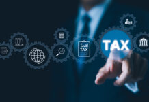 Businessman interact with digital gears representing various tax and financial icons, modern tax management and government regulations in digital economy.