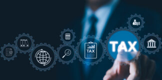 Businessman interact with digital gears representing various tax and financial icons, modern tax management and government regulations in digital economy.