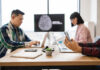 Team of IT experts collaborating on developments of artificial intelligence in office.