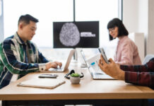 Team of IT experts collaborating on developments of artificial intelligence in office.