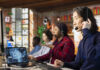 eam of multiethnic call center workers using AI chatbot to reply to common customer queries. Multiracial customer service coworkers generate automated responses to clients using AI