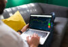 Man checking trading on laptop