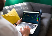 Man checking trading on laptop