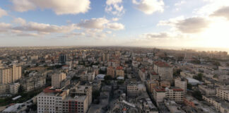 The destruction of Omar Al-Mukhtar Street in central Gaza and the rubble of Al-Shorouk Tower