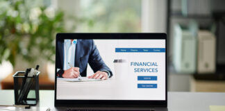 Financial services for business people, laptop with website on screen on office desk