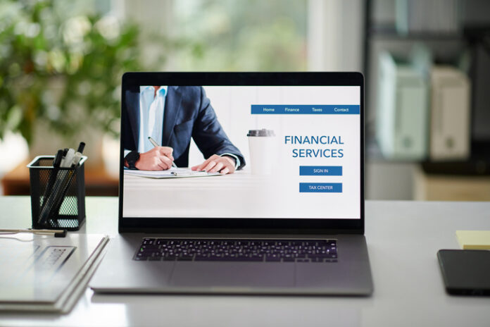 Financial Services for Business People Financial services for business people, laptop with website on screen on office desk