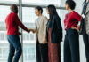 South–South Partnerships as Catalysts for Transformative Entrepreneurship Successful team introduction during a corporate meeting. Diverse professionals engaging in a positive interaction, fostering a collaborative office environment.