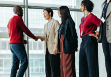 South–South Partnerships as Catalysts for Transformative Entrepreneurship Successful team introduction during a corporate meeting. Diverse professionals engaging in a positive interaction, fostering a collaborative office environment.