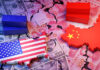 Symbolic image of US-China trade war showing cracked dollar and yuan banknotes, shipping containers, and country maps with flags.