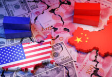 Symbolic image of US-China trade war showing cracked dollar and yuan banknotes, shipping containers, and country maps with flags.
