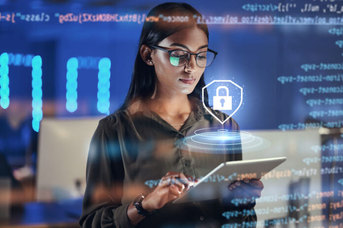 iStock-1552877787 (1) Lock hologram, tablet and woman with data analysis safety, software overlay and cyber security coding at night.