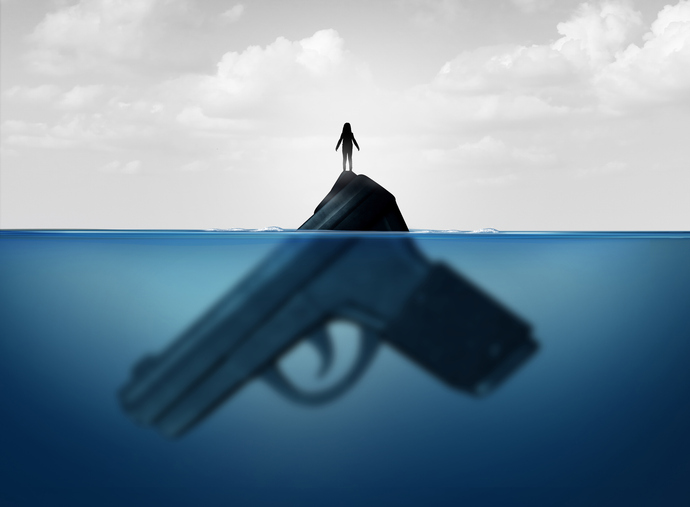 Gun concept as a child standing on a giant firearm submerged in water as a symbol for guns and violence and the risk of weapons
