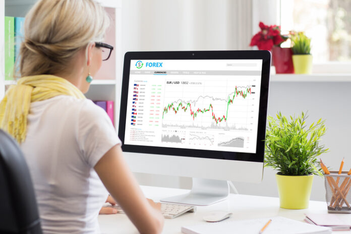 Woman trading currencies online on forex trading platform Woman trading currencies online on forex trading platform