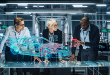 The Potential Impact of Generative Design on the Future of the Automotive Industry – A Socioeconomic and Political Perspective Diverse Team of Engineers Working in Office at Industrial Factory. Industrial Designers Discuss Electric Car Augmented Reality Hologramm. Specialists Work in Technological Car Development Facility.