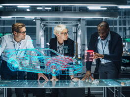 The Potential Impact of Generative Design on the Future of the Automotive Industry – A Socioeconomic and Political Perspective Diverse Team of Engineers Working in Office at Industrial Factory. Industrial Designers Discuss Electric Car Augmented Reality Hologramm. Specialists Work in Technological Car Development Facility.