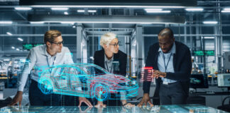 Diverse Team of Engineers Working in Office at Industrial Factory. Industrial Designers Discuss Electric Car Augmented Reality Hologramm. Specialists Work in Technological Car Development Facility.