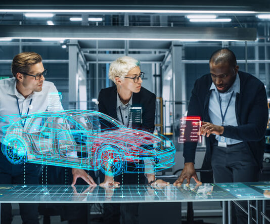 The Potential Impact of Generative Design on the Future of the Automotive Industry – A Socioeconomic and Political Perspective Diverse Team of Engineers Working in Office at Industrial Factory. Industrial Designers Discuss Electric Car Augmented Reality Hologramm. Specialists Work in Technological Car Development Facility.