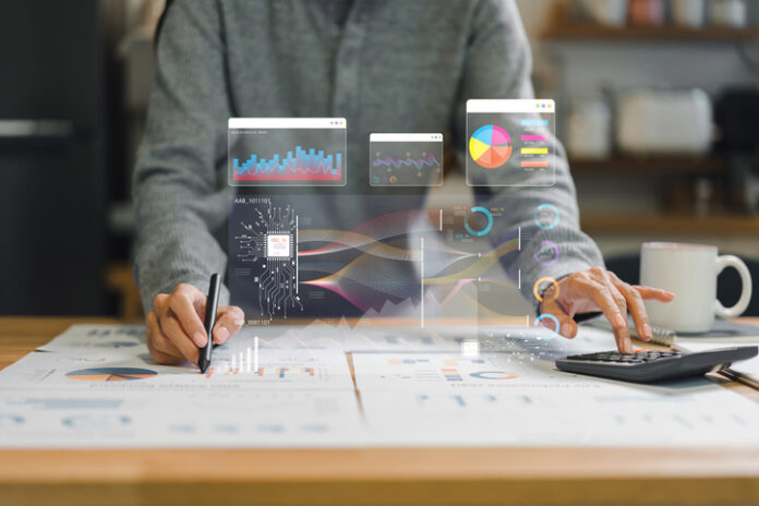 Analyzing data and creating visual reports with graphs and charts, person engages in strategic planning and decision making in modern workspace Accounting Services in Denver