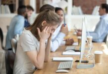 How “AI Workslop” is Draining Modern Enterprises Woman feeling tired of AI workslop