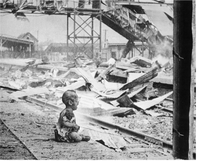 Terrified baby, one of the only human beings left alive in Shanghai's South Station after the brutal Japanese bombing in China.