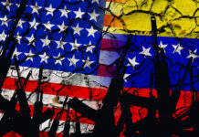Several automatic rifles raised up on the background of the American Venezuelan flag