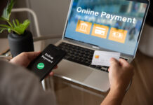 A person is using a laptop to pay for something online.