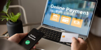 A person is using a laptop to pay for something online.