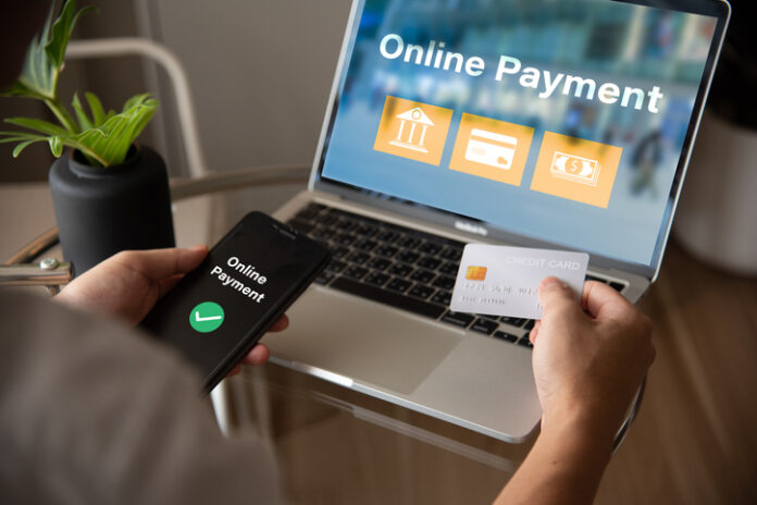 A person is using a laptop to payment online A person is using a laptop to pay for something online.