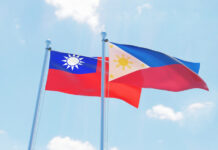 Philippines and Taiwan, two flags waving against blue sky.