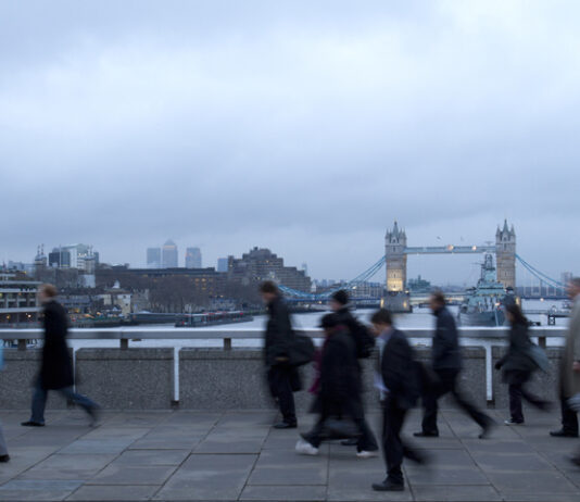 How Government Policy is Driving British Jobs Overseas Early morning rush hour, financial sector workers going to work in the City of London. UK Policy & Offshoring for overseas workers
