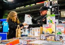 Fan buying merchandise of Japanese comics. Manga vs. American Comics