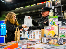 Fan buying merchandise of Japanese comics. Manga vs. American Comics