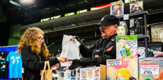 Fan buying merchandise of Japanese comics. Manga vs. American Comics