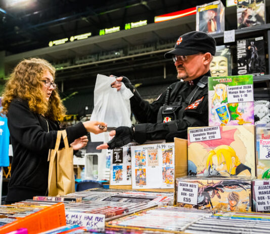 Japan Manga vs. American Comics: How ‘Janru’ Diversity and Innovation Drive Global Cultural Dominance Fan buying merchandise of Japanese comics. Manga vs. American Comics
