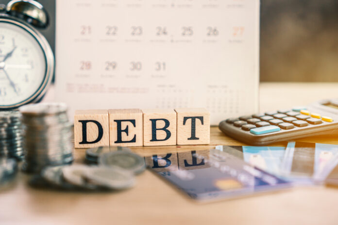 debt collection and tax season concept with deadline calendar remind note,coins,credit card,calculator on table Equity vs Debt vs Hybrid Mutual Funds