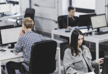 Taming the Gen AI Disruption With Regular Check-ins People working in office