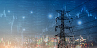 Market stock graph and information with city light and electricity and energy facility industry and business